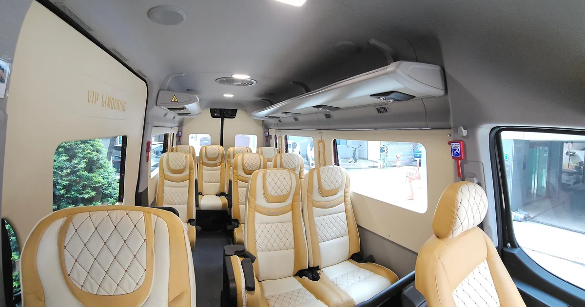 Twelve tan leather seats inside a private airport van for groups travelling between Incheon Airport and Seoul
