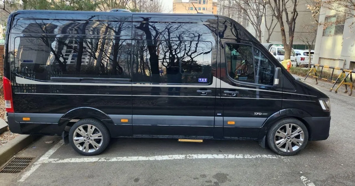 A black private van parked outside a Seoul hotel after an Incheon Airport pickup