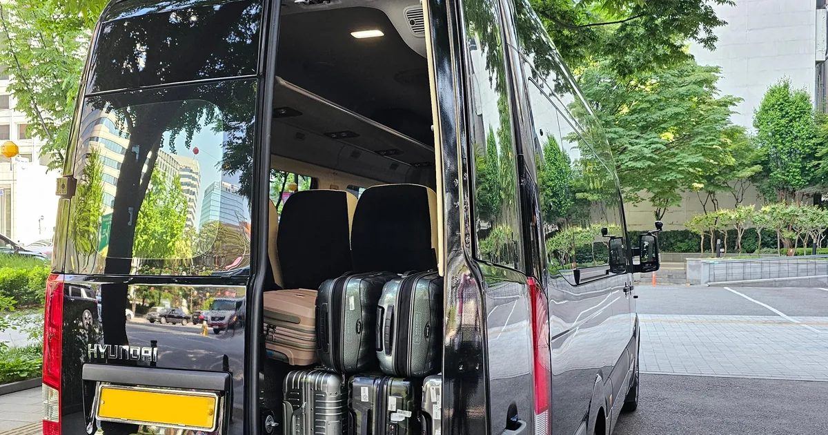 The open back of a private van loaded with suitcases at Incheon Airport for a late-night transfer to Seoul